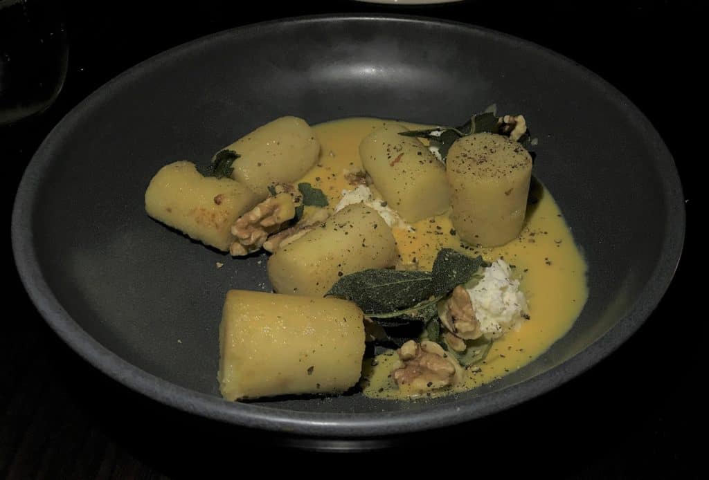 Potato gnocchi with pumpkin cream, fetta, sage, and walnuts  